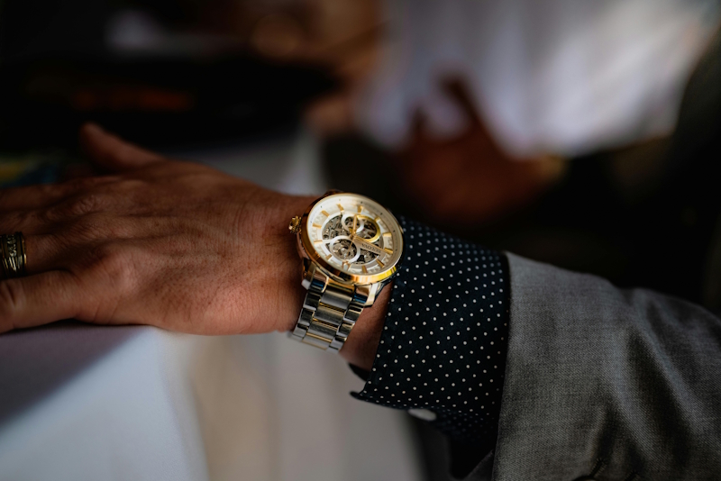 a gold watch on a man's wrist