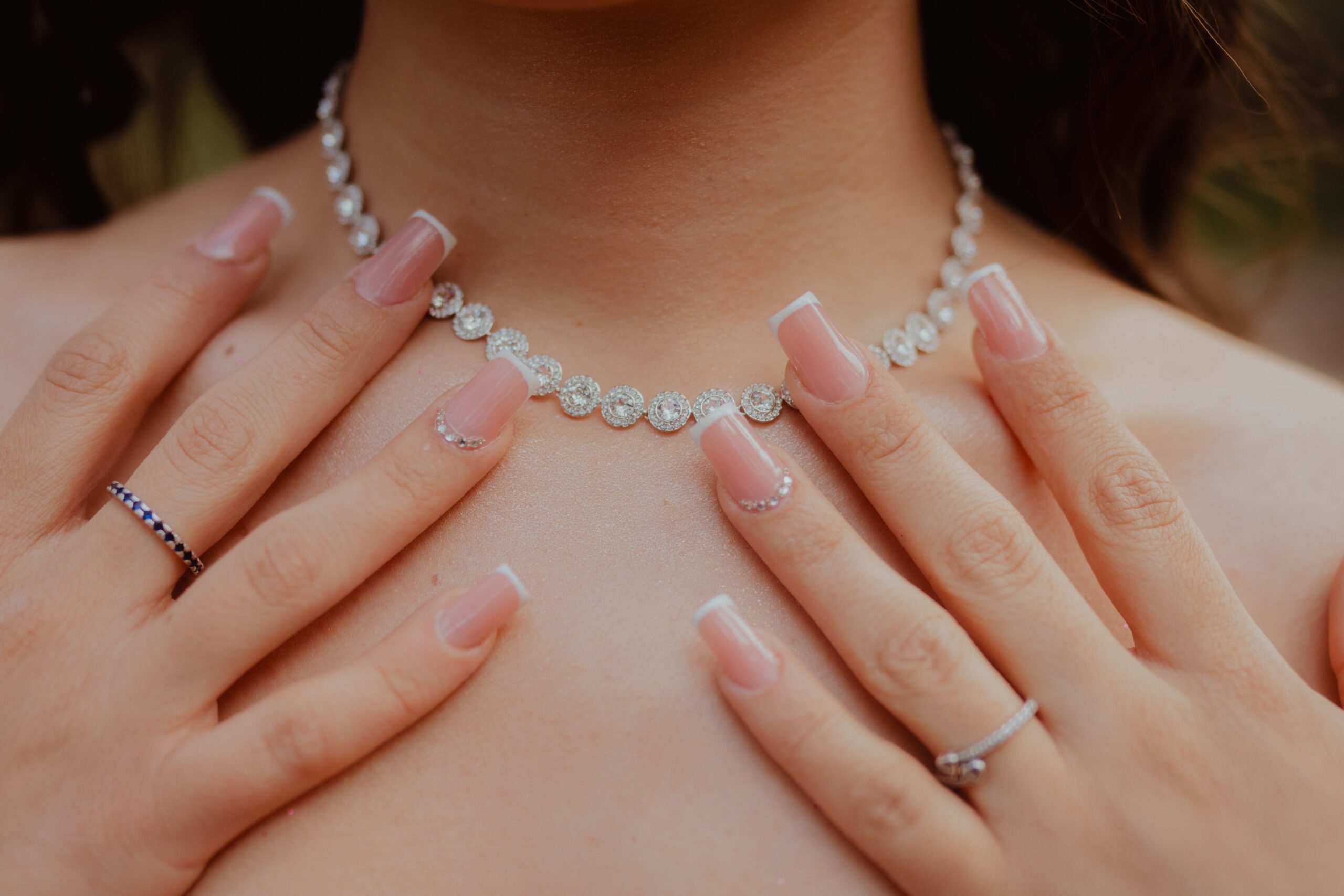 woman touching a necklace around her neck