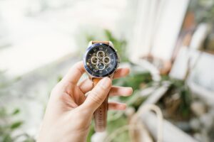 a hand holding a watch